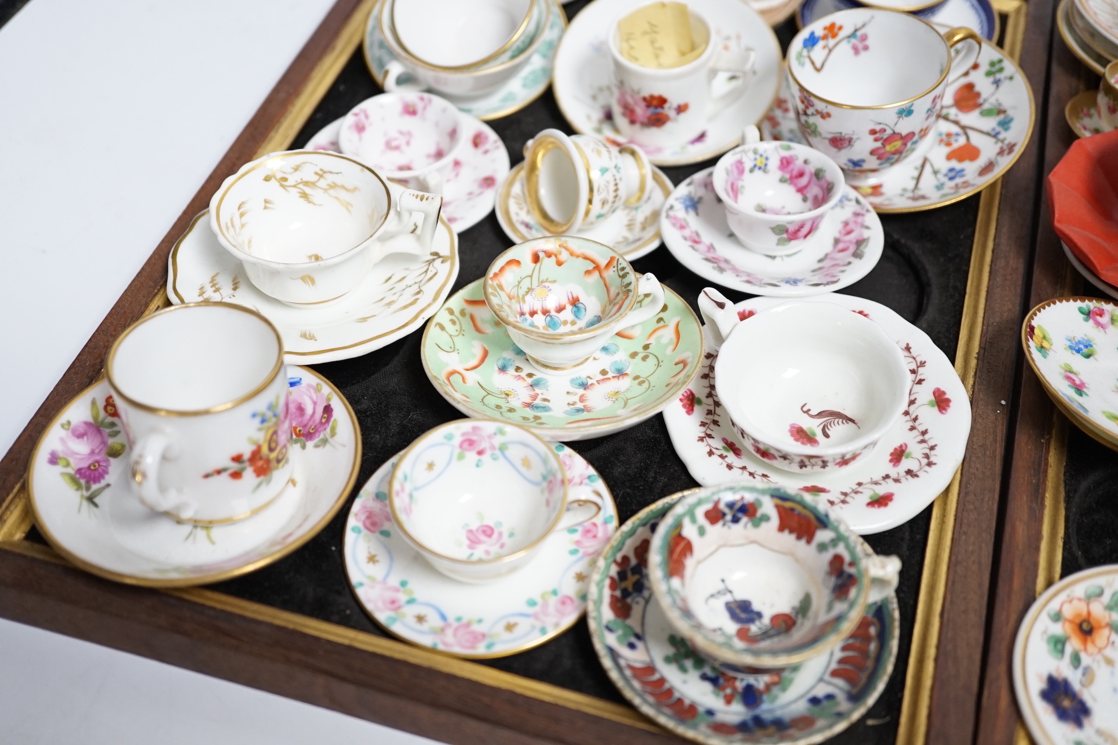 Collection of miniature porcelain cups and saucers including Spode, Royal Crown Derby and Coalport